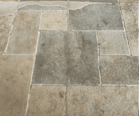 Dirty natural stone patio before professional cleaning