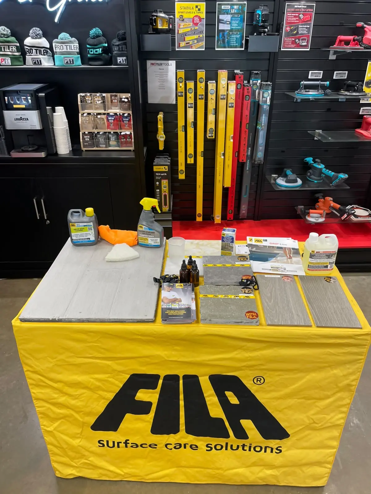 Fila surface-care demonstration table with professional products and samples
